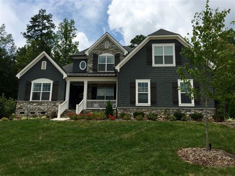 houses painted dark grey with metal roofs|gray exterior with black trim.